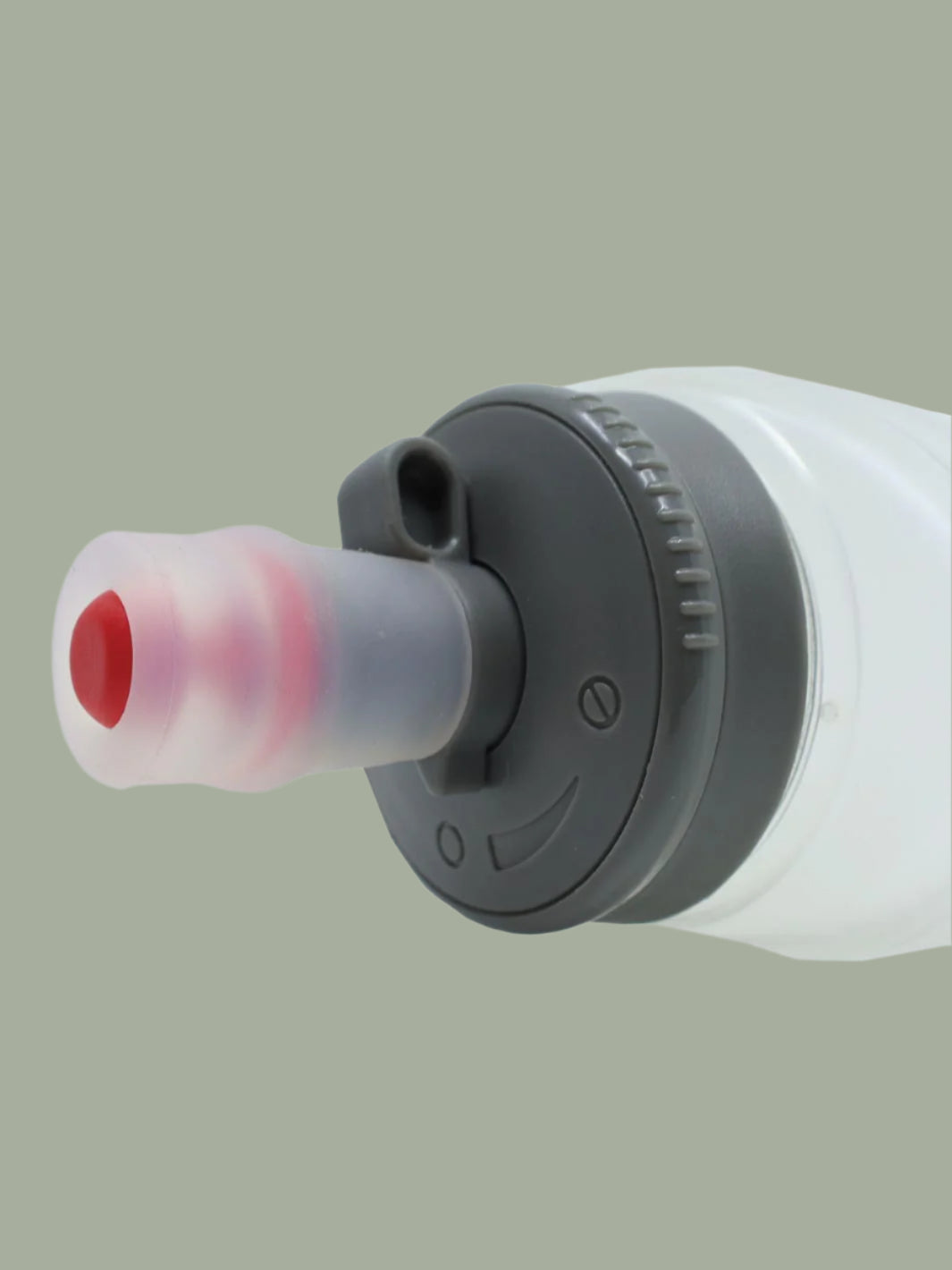 Close-up of a white and gray ultraspire soft flask locking lid with a red component on a light green background