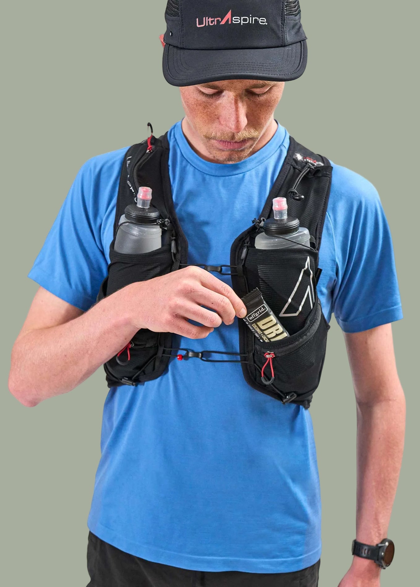 Person wearing a Ultraspire Zygos V6 hydration vest with Ultra Aspire cap and bottles.